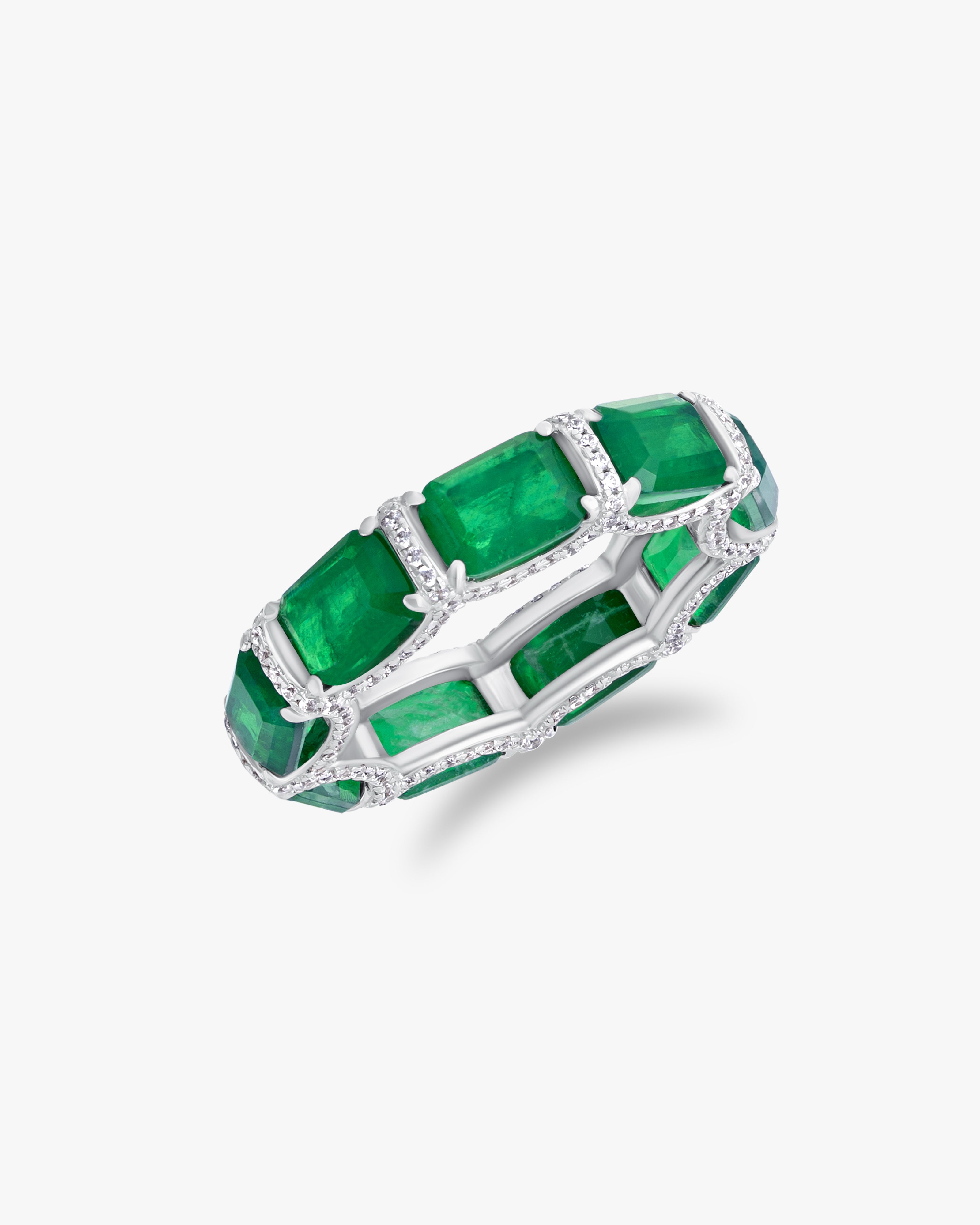 Ring with emerald cut green stones