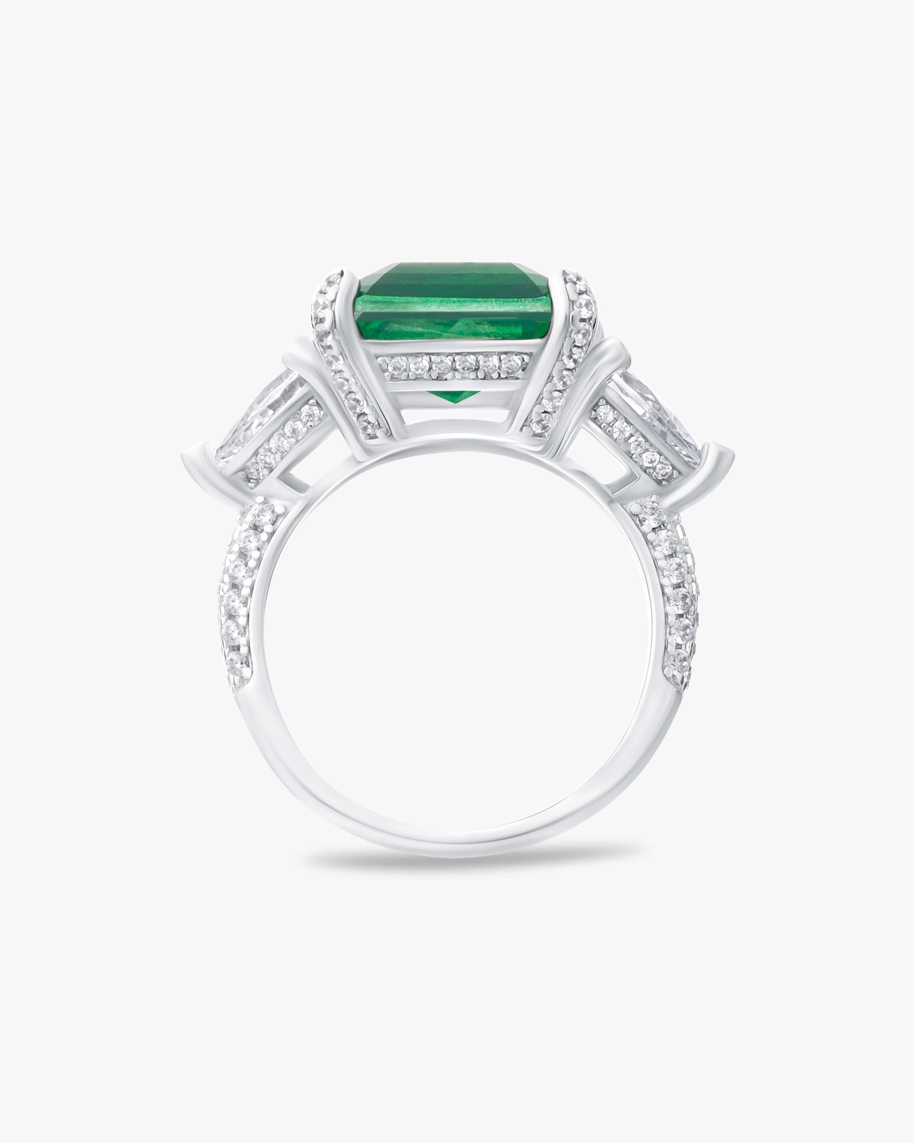 Ring with emerald green center stone and pear cut accents