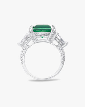 Ring with emerald green center stone and pear cut accents