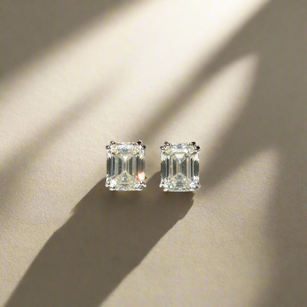 Earrings with emerald cut white stones