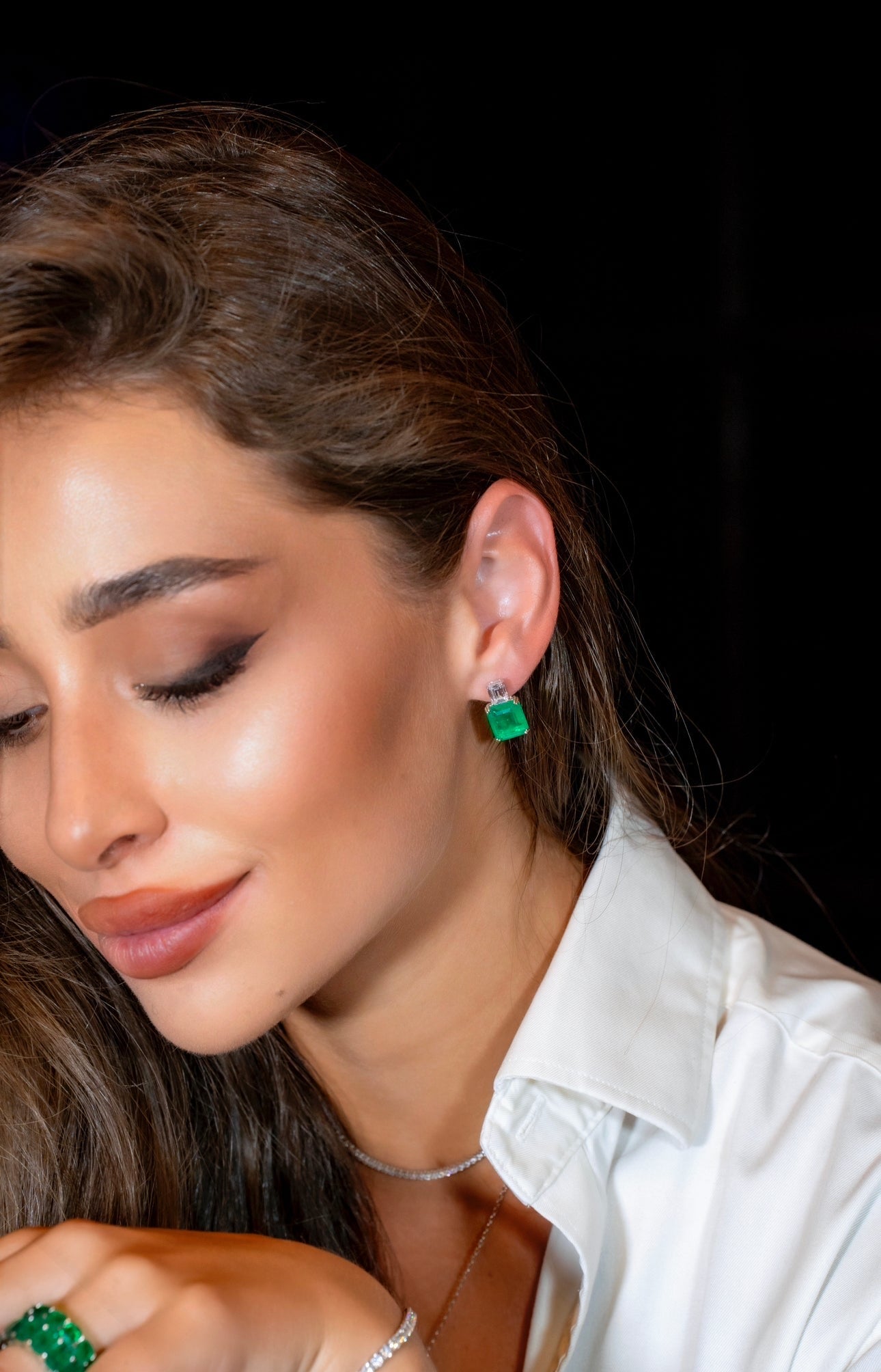 Earrings with emerald cut green stones