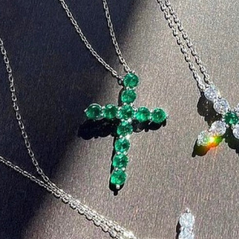 Pendant cross with round cut green stones