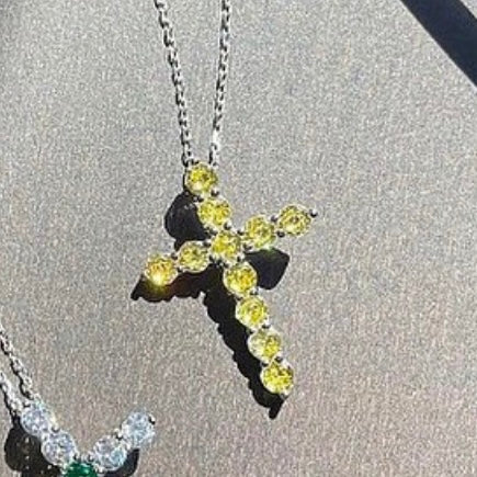 Pendant cross with round cut yellow stones