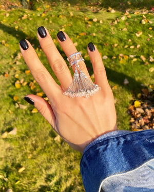 Ring with two white tassels