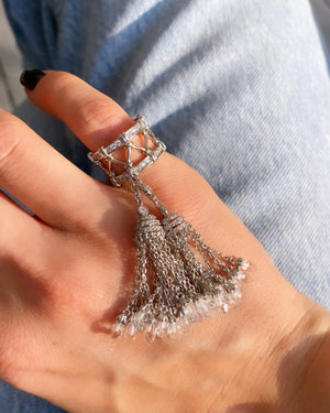 Ring with two white tassels